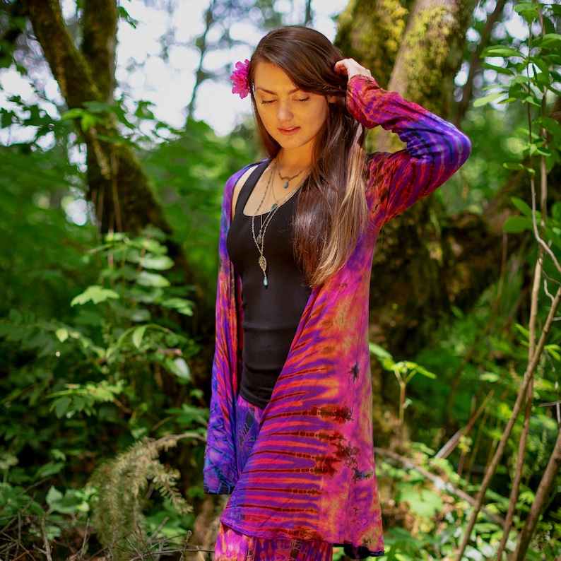 Model wearing Purple Tie Dye Long Cardigan with stripes and starburst patterns in yellow, gold, orange, pink and fuchsia
