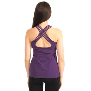 May include: Purple tank top with a criss-cross strap design at the back.