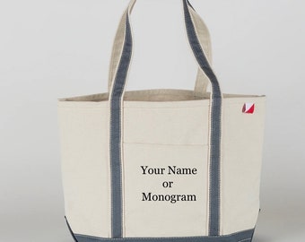 May include: A white canvas tote bag with gray trim and handles. The bag has a small red and white label on the side. The bag is personalized with the text "Your Name or Monogram".