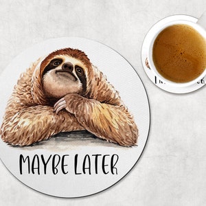 May include: A round coaster with a watercolor illustration of a sloth with the text "Maybe Later".