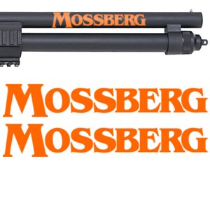 May include: A black shotgun with an orange "Mossberg" logo on the barrel. The logo is repeated twice below the image of the shotgun.