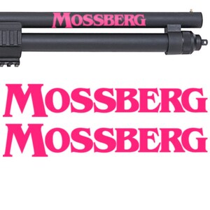 May include: A black shotgun with a pink "Mossberg" logo on the barrel. The logo is repeated twice below the image of the shotgun.