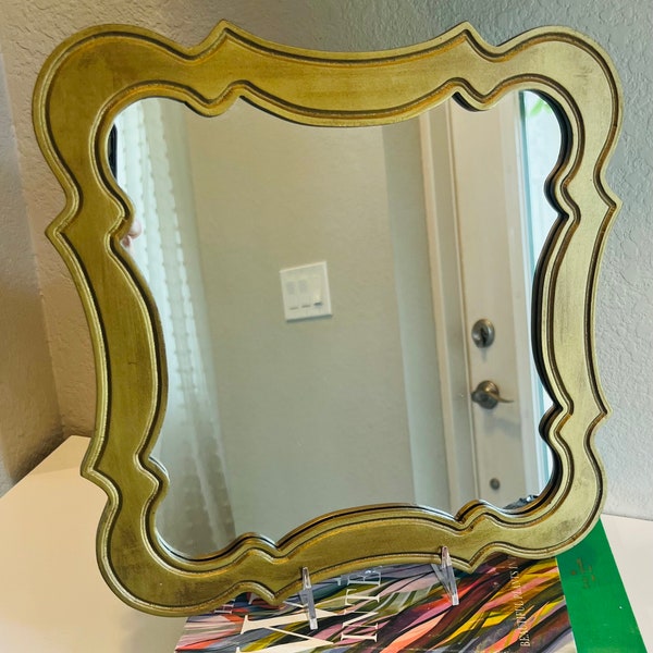 Vintage Brassy Gold Framed Mirror, wavy wood. 12” by 12”