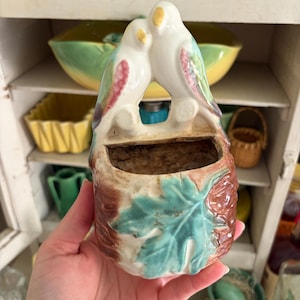 May include: A rustic wooden sign with the text "Welcome to our home" in a handwritten style. The sign features a distressed finish and a simple, inviting design, perfect for a front porch or entryway.