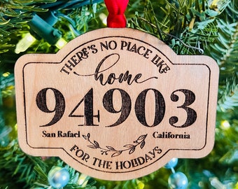 May include: A wooden Christmas ornament with the text "There's no place like home 94903 San Rafael, California for the holidays".
