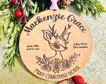 May include: A wooden Christmas ornament with a deer design, the text "Mackenzie Grace", "June 15th at 5:11 am", "5 lbs 15 oz 18 1/2 inches", and "First Christmas 2022".