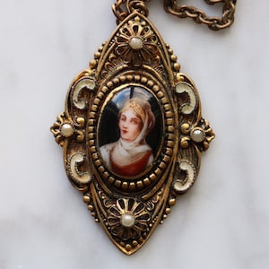 Antique portrait pendant necklace mounted in brass with faux pearl and enamel