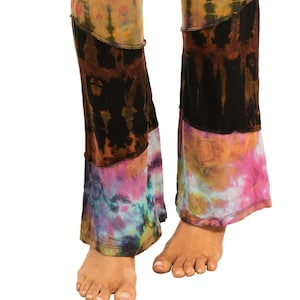 Puede incluir: Pantalones tie-dye multicolores con un diseño de patchwork. Los pantalones están hechos de una tela suave y elástica y tienen un ajuste cómodo.