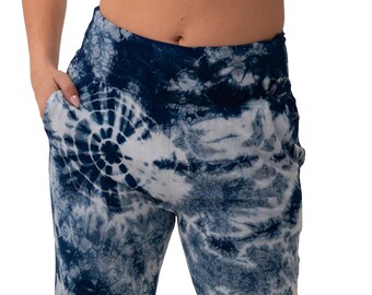 May include: Blue and white tie-dye pants with a loose fit and elastic waistband. The pants are made of a soft, comfortable fabric and have a relaxed, casual style.