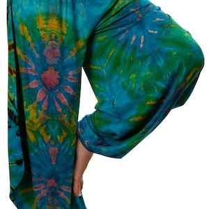 May include: A pair of blue, green, and yellow tie-dye pants with a wide leg and a loose fit.