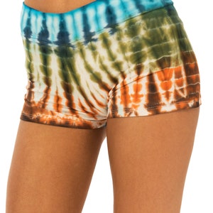 May include: Tie-dye shorts with a blue, green, orange and brown colour scheme. The shorts have a high waist and a relaxed fit.