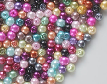 May include: A large assortment of colorful pearl beads. The beads are round and have a smooth, glossy finish. They are perfect for jewelry making, crafts, and other creative projects.