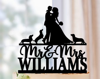 May include: Black silhouette cake topper featuring a bride and groom kissing with two dachshund dogs. The topper also includes the text "Mr. & Mrs. Williams".