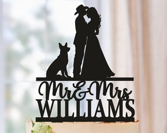 Peut inclure: Topper de gâteau en silhouette noire représentant un couple en chapeau de cowboy, un chien et le texte "Mr. & Mrs. Williams".