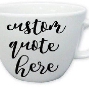 May include: White ceramic mug with a black cursive inscription that reads "custom quote here".