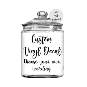 May include: A clear glass jar with a lid, featuring a black vinyl decal that reads "Custom Vinyl Decal Choose your own wording".