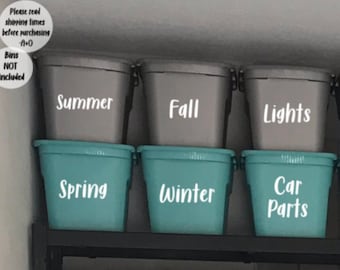 Op de afbeelding: Zes grijze plastic opbergbakken met witte etiketten. De etiketten lezen "Summer", "Fall", "Lights", "Spring", "Winter", en "Car Parts".