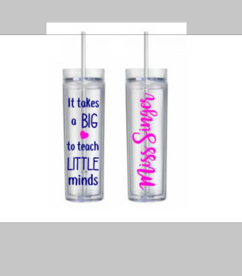 May include: Two clear plastic tumblers with straws. One tumbler has the text "It takes a BIG heart to teach LITTLE minds" in navy blue with a pink heart. The other tumbler has the text "Miss Singer" in pink.