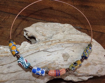 Short necklace in Ghana glass beads and copper beads on copper metal neckline.