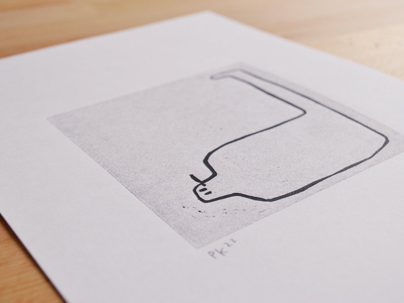 May include: A black and white line drawing of a curved shape resembling a bottle or a vase. The drawing is on a white background with the text "PK22" in the bottom right corner.