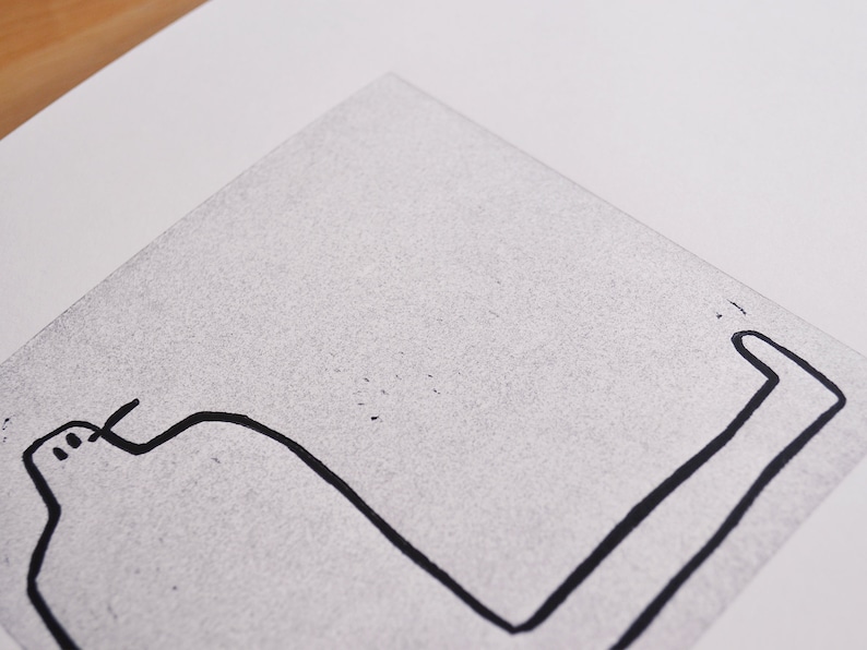 May include: A black and white line drawing of a person sitting with their legs stretched out in front of them.