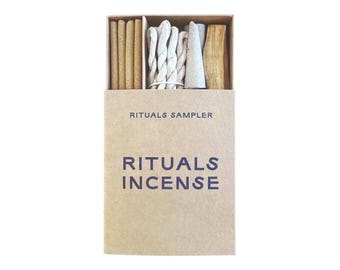 May include: A brown cardboard box with the text "RITUALS SAMPLER" and "RITUALS INCENSE" printed on the front. The box contains a variety of incense sticks and cones.