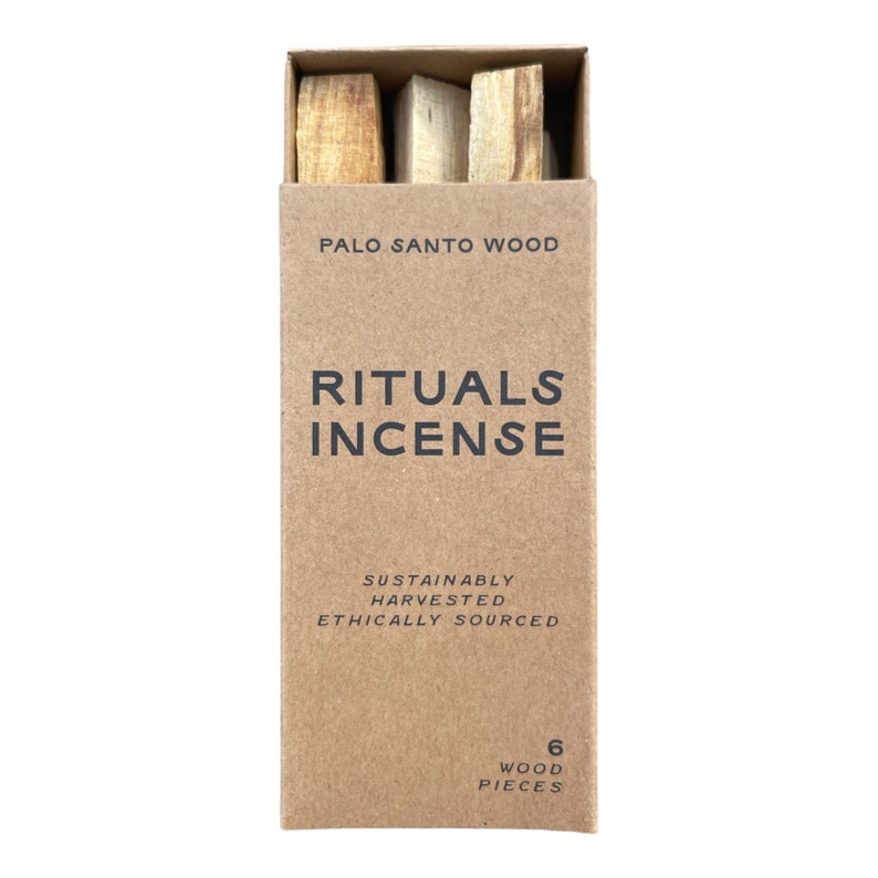 May include: A rectangular box of Palo Santo wood incense. The box is light brown with the words "RITUALS INCENSE" in large, dark letters. The box also states "SUSTAINABLY HARVESTED ETHICALLY SOURCED" and contains 6 wood pieces.