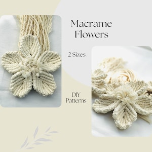 May include: Two white macrame flower wall hangings, one larger than the other. The text "Macrame Flowers" and "2 Sizes" is visible in the image. The text "DIY Patterns" is also visible in the image.