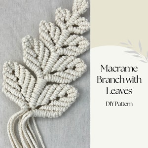May include: A macrame branch with leaves, made from off-white cotton cord. The leaves feature an open weave design. The image includes the text "Macrame Branch with Leaves DIY Pattern".