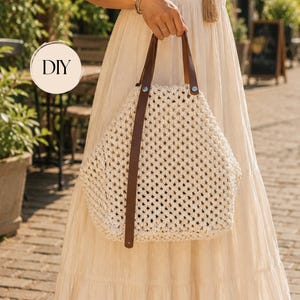 May include: A cream-colored macrame tote bag featuring a diamond-patterned woven design, two brown leather straps attached with silver-tone metal rivets, and a circular graphic in the upper left corner containing the black text DIY.