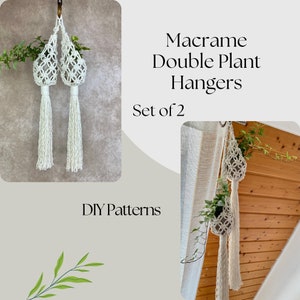May include: A set of two white macrame plant hangers with tassels. The hangers are made with a knotting technique and are designed to hold small potted plants. The image includes the text "Macrame Double Plant Hangers Set of 2 DIY Patterns".