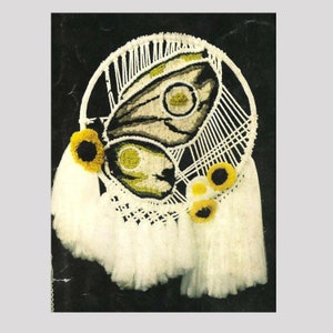 May include: A white macrame wall hanging with a butterfly design and yellow sunflower accents. The butterfly is made of yarn and has a brown and white pattern.