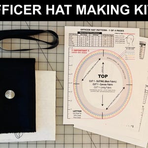 May include: Officer hat making kit with pattern instructions. Includes black fabric, a black band, a silver button, and white fabric. The pattern includes measurements and cutting guides. The text "OFFICER HAT MAKING KITS" is at the top.