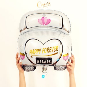 May include: White car shaped foil balloon with pink hearts and the text "Happy Forever" and "Mr & Mrs" in gold lettering.