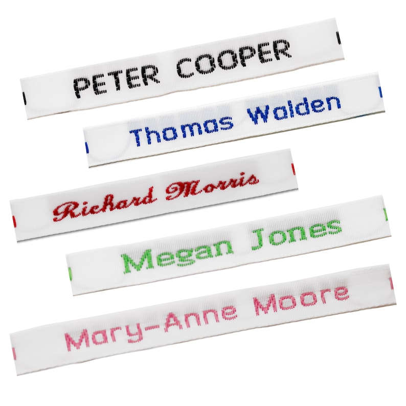 May include: Five white fabric labels with different names embroidered in various colors. The names are "Peter Cooper", "Thomas Walden", "Richard Morris", "Megan Jones", and "Mary-Anne Moore".
