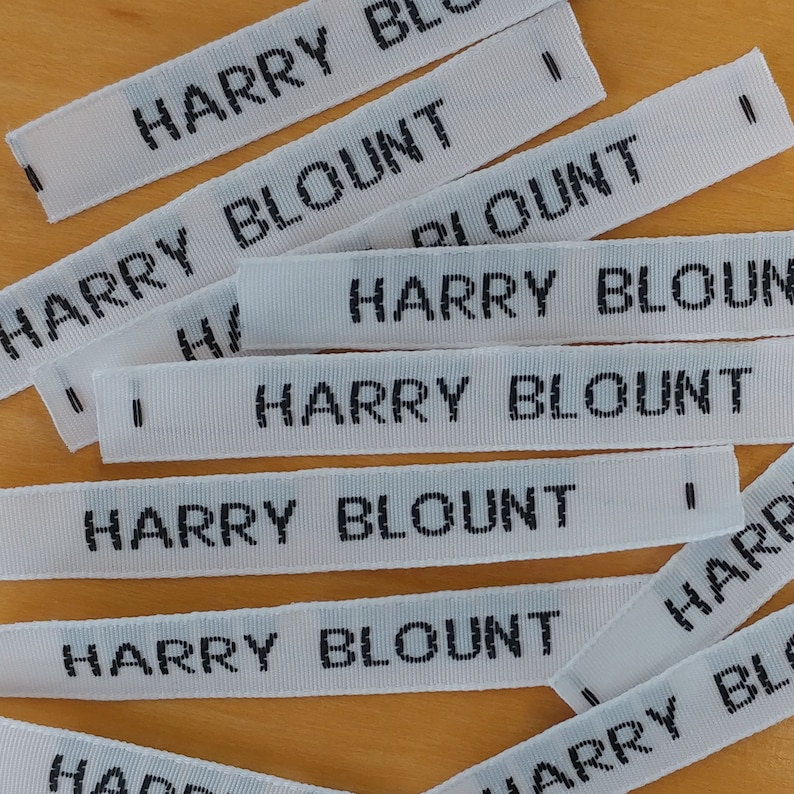 May include: Multiple white woven labels with black text reading "HARRY BLOUNT" in a stacked arrangement.