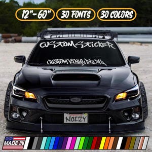 May include: A black car with a custom sticker on the windshield. The sticker reads "CUSTOM STICKER" and "CUSTOM VINYL DECAL". The image also shows a variety of color options and the text "12"-60" 30 FONTS 30 COLORS".