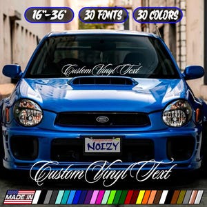 May include: A blue car with the text "Custom Vinyl Text" in white script on the windshield. The image includes text that says "16"-36", "30 FONTS", and "30 COLORS". The car has a license plate that says "NOIZY".