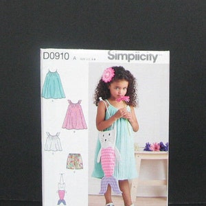 May include: Simplicity sewing pattern D0910 for a girl's dress and mermaid purse. The pattern includes instructions for making a dress with a variety of skirt styles, including a gathered skirt, a tiered skirt, and a ruffled skirt. The pattern also includes instructions for making a mermaid purse with a pink and white striped tail.