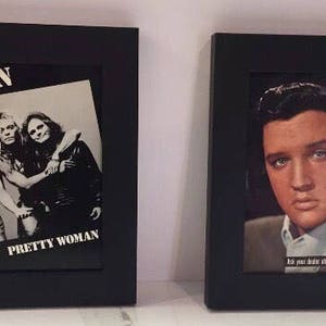 May include: Two framed album covers. One features the band Van Halen with the text "Pretty Woman". The other features Elvis Presley with the text "Elvis Sings" and song titles "Return to Sender" and "Where Do You Come From".