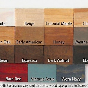 May include: A grid of fourteen rectangular wood stain samples labeled White, Beige, Colonial Maple, Cherry, Golden Oak, Early American, Honey, Weathered Gray, Jacobean, Espresso, Dark Walnut, Ebony, Barn Red, Vintage Aqua, and Worn Navy.