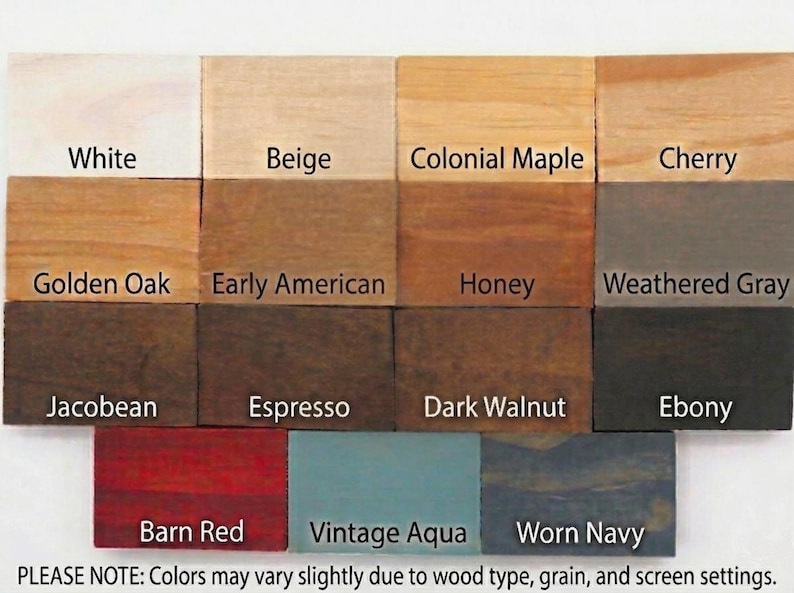 May include: A grid of fourteen rectangular wood stain samples labeled White, Beige, Colonial Maple, Cherry, Golden Oak, Early American, Honey, Weathered Gray, Jacobean, Espresso, Dark Walnut, Ebony, Barn Red, Vintage Aqua, and Worn Navy.