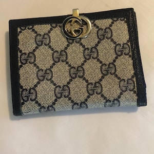 Cartera plegable italiana de lujo con logo GG Web en lona y piel negra con G entrelazada de latón