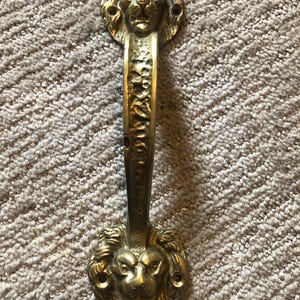Brass double lion head door handle 9” circa 1940