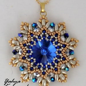 May include: A gold chain necklace with a blue and silver beaded pendant in the shape of a star. The pendant features a large blue crystal in the centre.