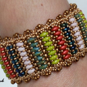 May include: A colorful beaded bracelet with a geometric pattern. The bracelet is made with gold, red, green, blue, and white beads.