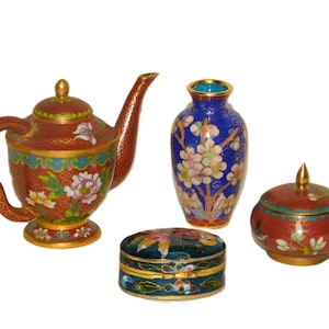 May include: A set of four decorative Chinese cloisonné pieces, including a teapot, a vase, and two small boxes. The pieces are all decorated with intricate floral patterns in shades of red, blue, green, and gold.