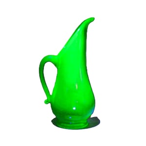 May include: A tall, bright green pitcher with a curved handle and a long, slender spout. The pitcher has a rounded base and a smooth, glossy finish. The design is reminiscent of mid-century modern decor.