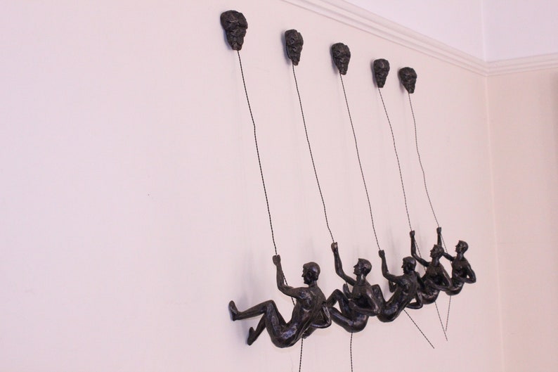 bronze abseiling figures