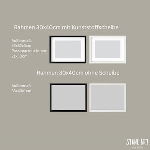May include: Four rectangular picture frames, two black and two white, are displayed against a neutral background. The frames are labeled with dimensions and text in German. The bottom frames measure 33x43x1cm.